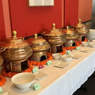 a long table with bowls of food on it