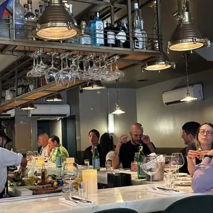 a group of people sitting at a bar