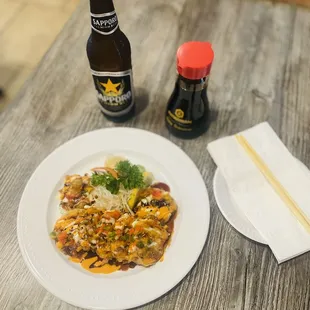 a plate of food and a bottle of beer