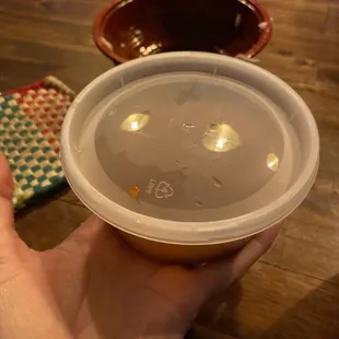 a person holding a bowl of soup