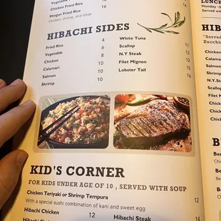 a hand holding a menu in a restaurant