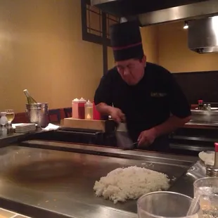 Talented chef catching an egg in his hat!