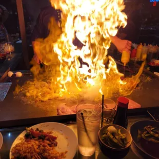 a man cooking food on a grill