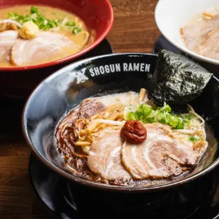 a bowl of ramen and two bowls of soup