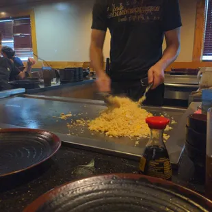a man wearing a face mask preparing food
