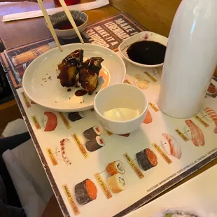 a plate of sushi with chopsticks
