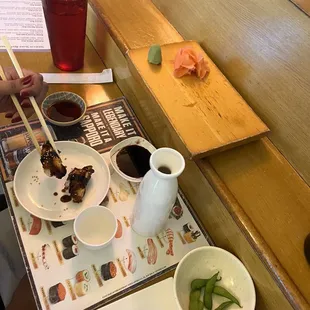 a woman eating sushi with chopsticks