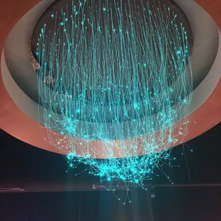 a circular chandelier suspended from the ceiling