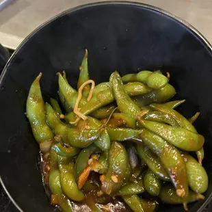 Spicy edamame. Temperature is warm and sauce is yummy