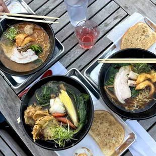 three bowls of ramen and bread