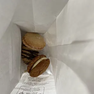 three cookies in a paper bag