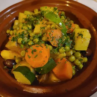 Vegetable Tagine  Carrots, red potatoes, artichoke hearts, peas and tomatoes. Slow cooked in olive oil and Moroccan spices.