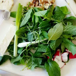 a plate of salad and a bowl of salad