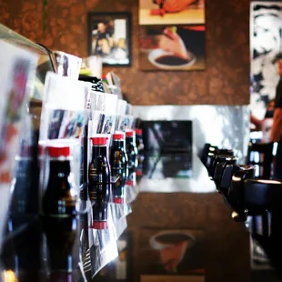 a row of beer bottles on a counter