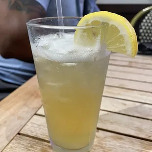 a glass of lemonade on a table
