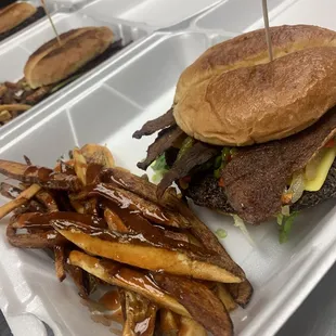 a burger and fries in a styrofoam container