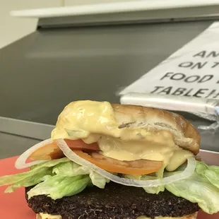 a cheeseburger with lettuce and tomato