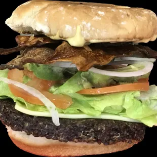 a burger with bacon and lettuce