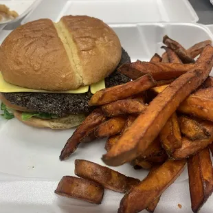 a hamburger and fries on a styrofoam tray