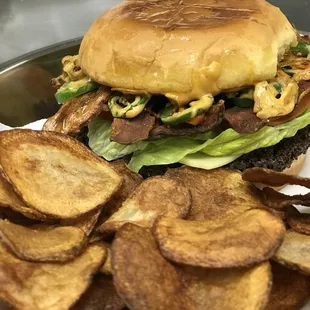 a burger and potato chips on a plate