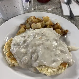 Sausage biscuits and gravy with home fries.