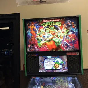 a pinball machine in a game room
