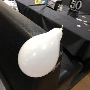 a white balloon on a black table