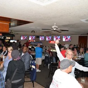 a crowd of people in a sports bar