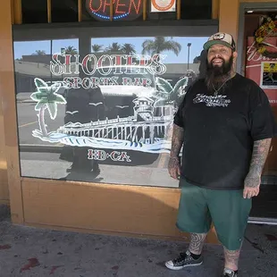 a man standing in front of a restaurant