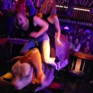 a woman riding on a fake animal