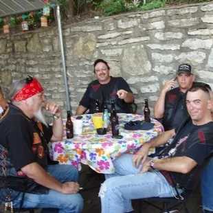 a group of bikers sitting around a table