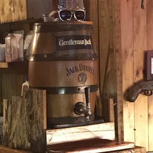 a wooden barrel with a glass on top