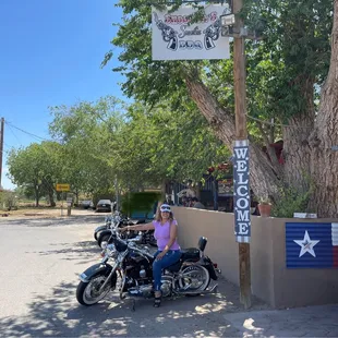 a woman sitting on a motorcycle