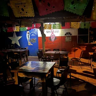 tables and chairs in a dimly lit room