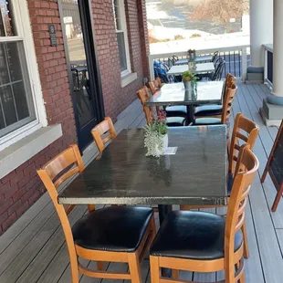 a table and chairs on a porch