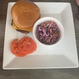 Cheeseburger with horse radish and tomato's on the side