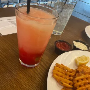 a plate of fries and a drink