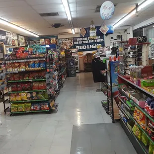 ows a wide aisle of a grocery store