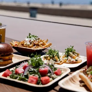 plates of food and drinks on a wooden table