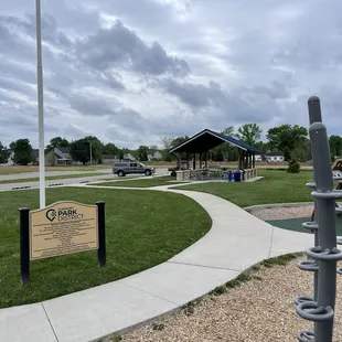 The other covered seating area with 2 more large charcoal grills large tables, rubbish bins and water fountains