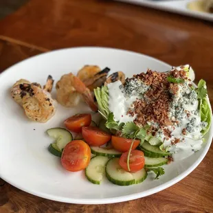 Blue cheese wedge salad with grilled shrimp. Very tasty.