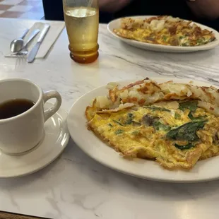 Coffee, veggie omelet with spinach, and potatoes
