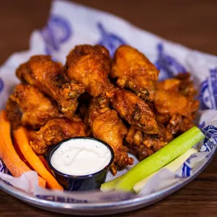 a plate of chicken wings and carrots