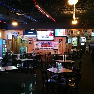 Pool tables behind, darts in the back.
