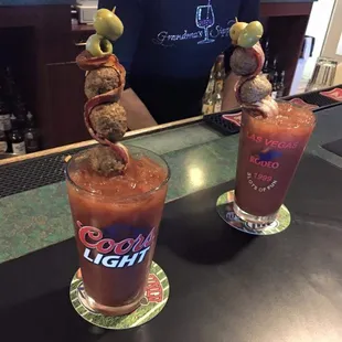 two bloody cocktails on a bar