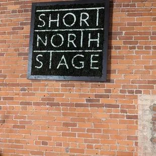 a sign on a brick wall