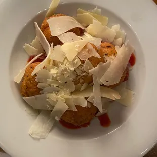 a plate of food with cheese and sauce