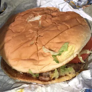 a hamburger with lettuce and tomatoes