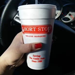 a hand holding a cup of coffee