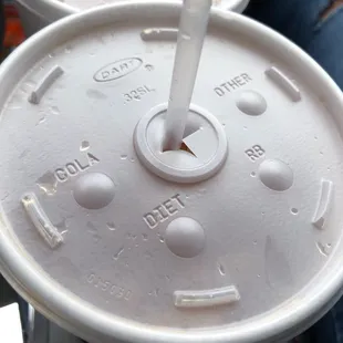 a close up of a plastic cup with a straw sticking out of it